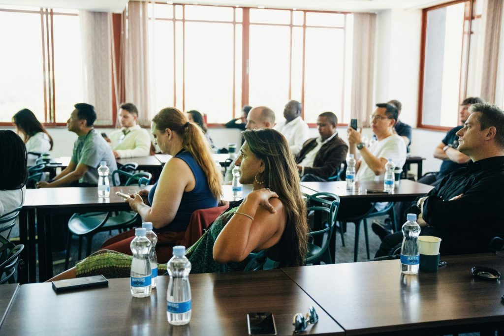 People sitting at tables in a conference room.